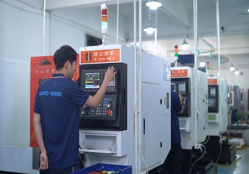 CNC operator setting the machine control panel