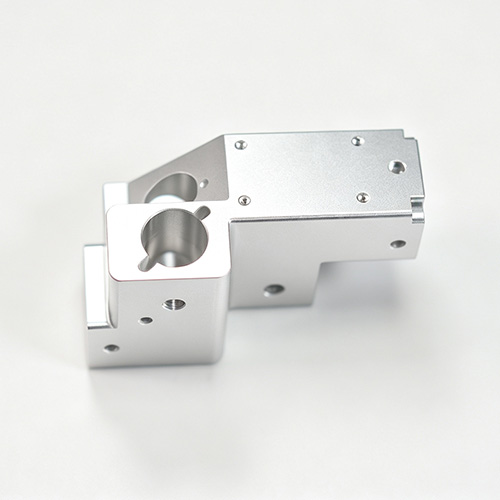 CNC machined aluminum housing block with threaded holes and heat sink fins